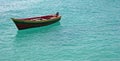 Single small fishing boat in turquoise ocean water Royalty Free Stock Photo