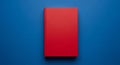 A Single Red Hardcover Book Centered on a Vibrant Blue Background blank Royalty Free Stock Photo