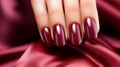 A single Solitary glamorous maroon nail polish on a maroon background