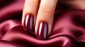 A single Solitary glamorous maroon nail polish on a maroon background