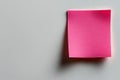 A single square pink sticky note adhered to a white background with shadows Royalty Free Stock Photo