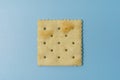 Single Square Saltine Cracker On Blue Background Royalty Free Stock Photo