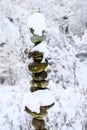 Single stack of snow covered round rocks in a peaceful snowy zen garden