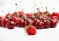 Single strawberry on background of cherries Royalty Free Stock Photo