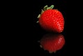 Single strawberry with reflection on black Royalty Free Stock Photo