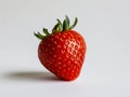 A single strawberry is shown on a white background Royalty Free Stock Photo