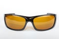 Sunglasses with black plastic frame and yellow glass on a white background Royalty Free Stock Photo
