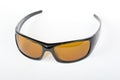 Sunglasses with black plastic frame and yellow glass on a white background Royalty Free Stock Photo