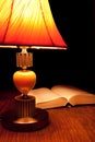 Single table-lamp and opened book