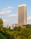 Single tall building overlooking a park Royalty Free Stock Photo