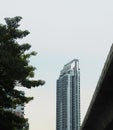 Single tall building with sky train track Royalty Free Stock Photo