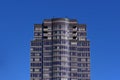 Single tall skyscaper building in a blue sky on Robson Street, Downtown Vancouver, Canada