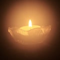 Single tea light candle in the dark Royalty Free Stock Photo