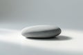 a simple grey stone on a light surface Royalty Free Stock Photo
