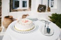 Single tier wedding cake decorated with petals and shells