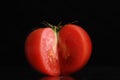 Single tomato isolated on black background Royalty Free Stock Photo
