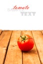 Single tomato on wooden table Royalty Free Stock Photo