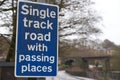 Single track road sign just before a very narrow road