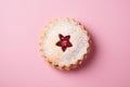 Single traditional Linzer Christmas cookie with shortcrust pastry and jam filling on pink background Royalty Free Stock Photo