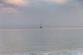 A single sailboat on a calm ocean