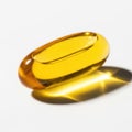 Close up of a yellow gel capsule reflecting light showing its smooth texture Royalty Free Stock Photo