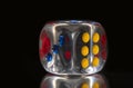 Single Transparent colorful dice on black background