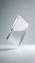 Minimalist clear glass block floating in studio with soft light and shadow Royalty Free Stock Photo