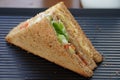 A single Tuna sandwich on black serving plate. One Club Sandwich with chicken, ham, cheese, tomatoes, cucumber, bacon, lettuce, Royalty Free Stock Photo