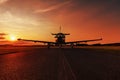 Single turboprop aircraft on evening runway.