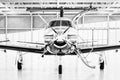 Single turboprop aircraft Pilatus PC-12 in hangar. Stans, Switzerland Royalty Free Stock Photo