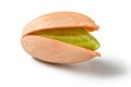 Single Turkish red pistachio, peeled green nut visible, isolated on white background Royalty Free Stock Photo