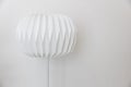 The single unique round shape paper electric floor lamp on white wall background