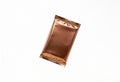 Shiny copper foil wrapper for a candy bar or snack on a white background Royalty Free Stock Photo