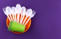Single-use plastic objects, ecological pollution. Plastic waste. Orange, white and green packaging plastic products, top view flat Royalty Free Stock Photo