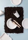 Single-use tableware dinnerware popular non-plastic alternatives on ground on blue flat lay composition, top view Royalty Free Stock Photo