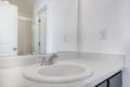 Single vanity sink with white marble countertop on a white bathroom