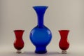 Single vintage blue vase and two red candle holders Royalty Free Stock Photo