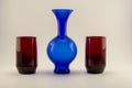 Single vintage blue vase and two red candle holders Royalty Free Stock Photo