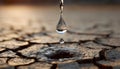 Single Water Drop Falling Into Cracked Earth Symbolizing Drought and Hope Royalty Free Stock Photo