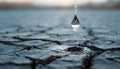 Single Water Drop Falling Into Cracked Earth Symbolizing Drought and Hope Royalty Free Stock Photo