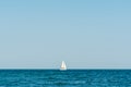 single white boat on the black sea