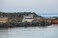 Single white boat near the stone pier. Royalty Free Stock Photo