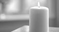 Single white candle burning softly in a calm interior with cloud dancer inspired tones and gentle light, close-up Royalty Free Stock Photo