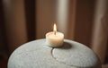 Single White Candle on Gray Stone Royalty Free Stock Photo