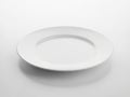 Single white ceramic plate on plain background Royalty Free Stock Photo