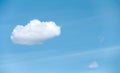 Single white cloud floating with breeze on bright blue sky background in summer day , copy space