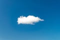 Single white cloud floating in clear blue sky with minimal background Royalty Free Stock Photo