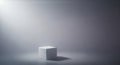 Single white cube illuminated by dramatic spotlight on gray background Royalty Free Stock Photo