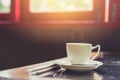 single white cup of espresso hot coffee with morning sun light from windows Royalty Free Stock Photo