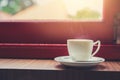 Single white cup of espresso hot coffee with morning sun light from windows Royalty Free Stock Photo